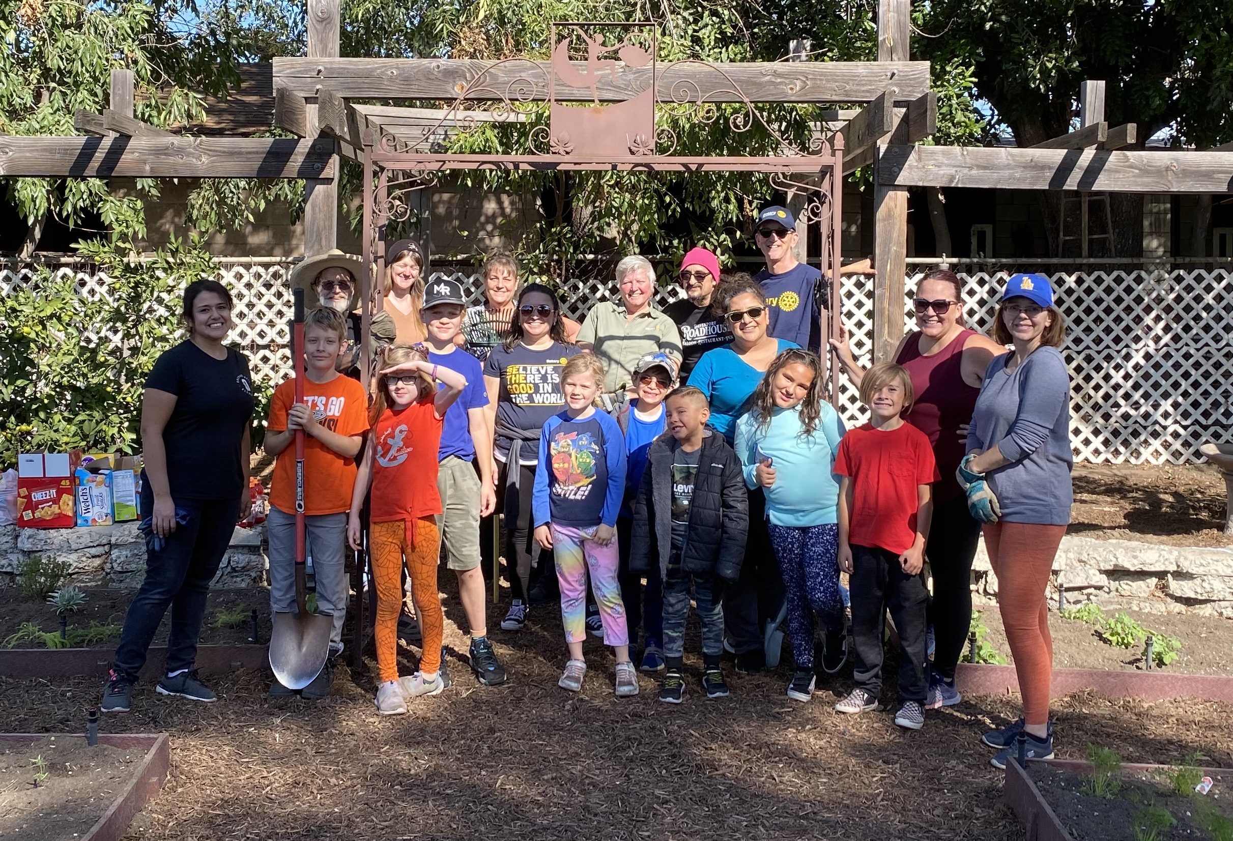 Photo of Rotarians and children in pollinator garden